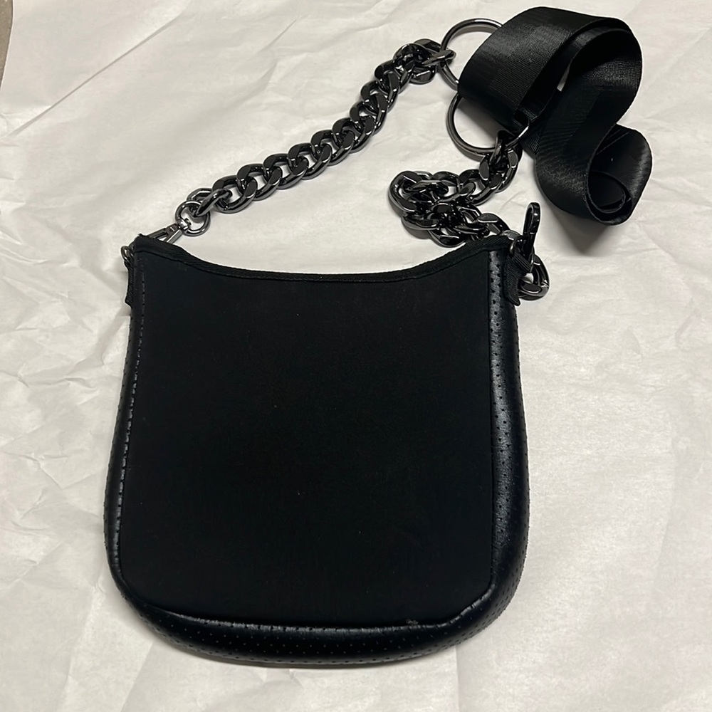 Haute shore neoprene cross body with fun metallic strap.